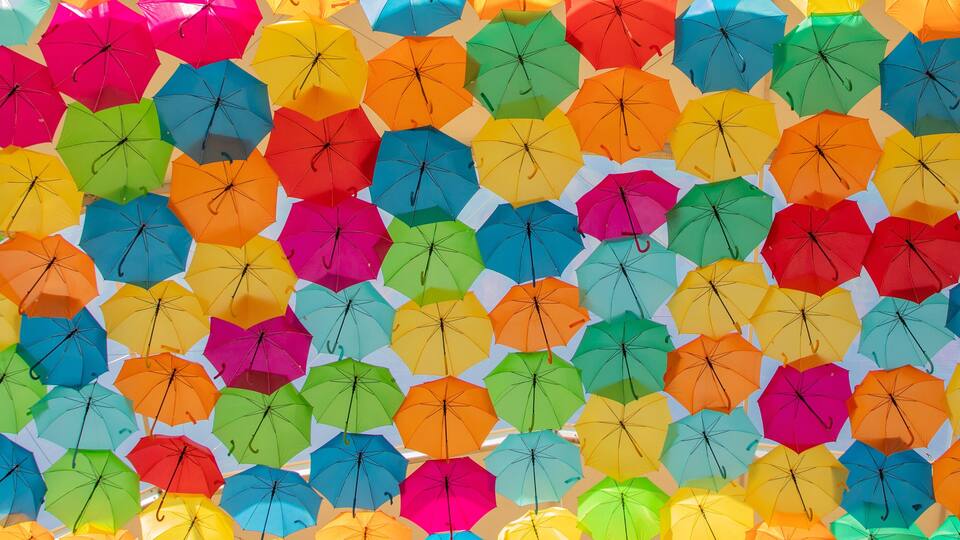A wall of colorful umbrellas in various shades.