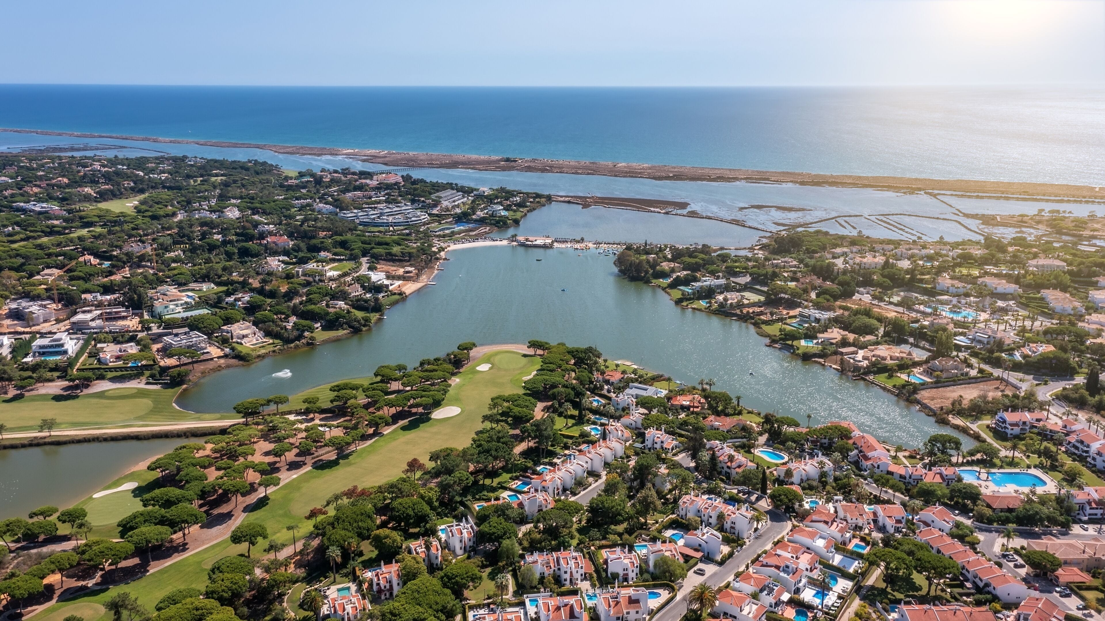 Aerial overview of luxury villas located around Quinta do Lago, Algarve, Portugal, Europe. Drone shot in the green zone.
