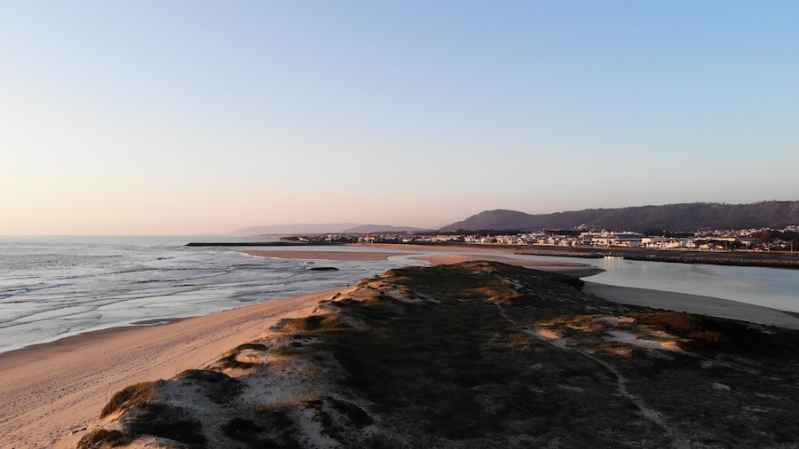 Aerial view of the Northern Litoral Natural Park in Ofir, Fao, Esposende, Portugal at sunset. The two sides of Restinga de Ofir. One facing the ocean, the other the estuary of Cávado River.