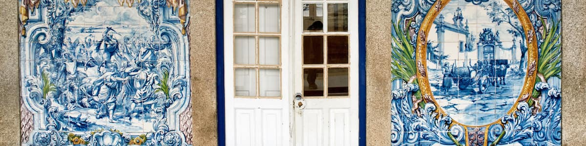 A white door with blue decorative tiles on either side.