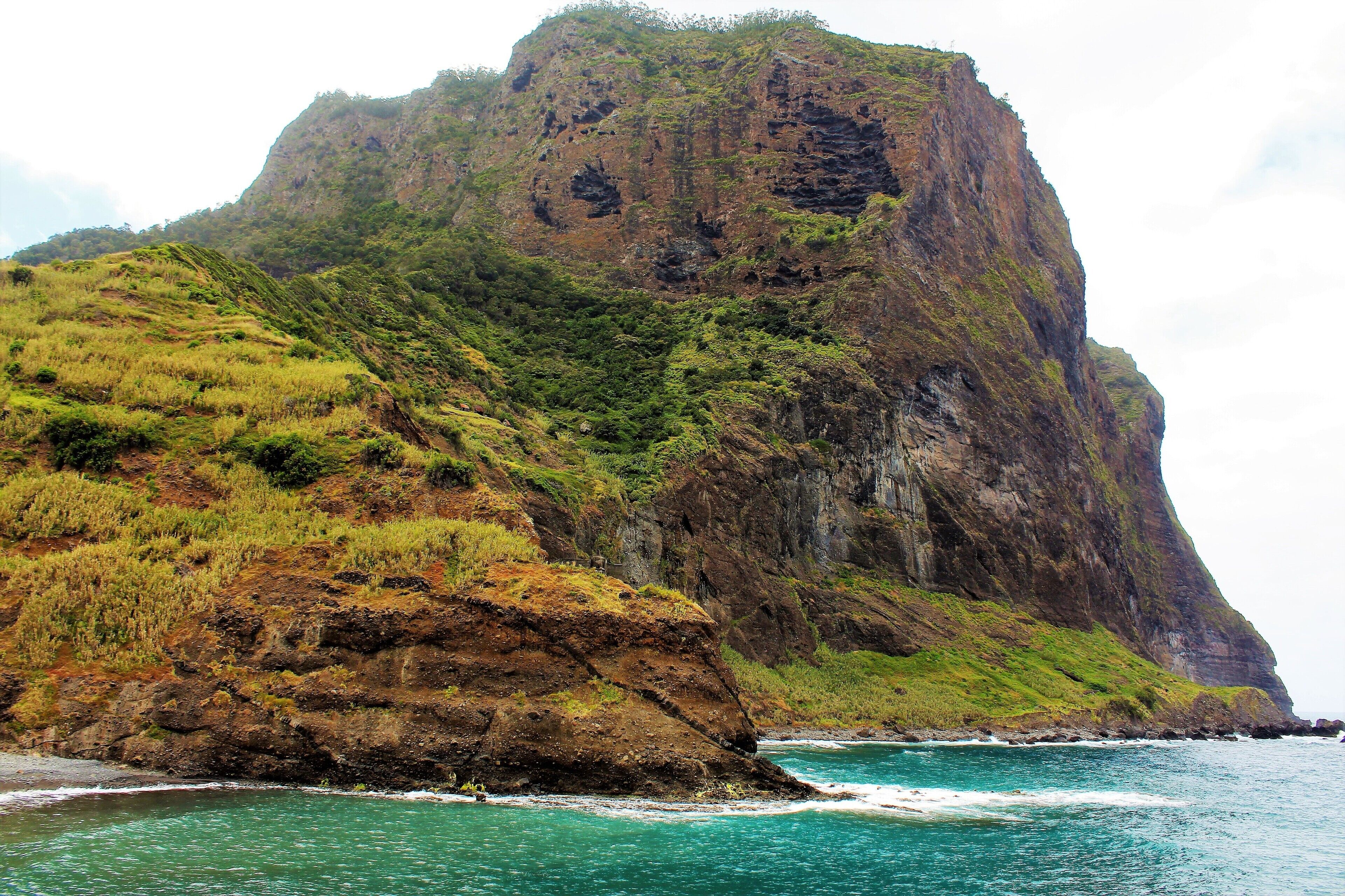 I took this in May on Madeira Island, Portugal! This is one of the most majestic sights I saw on this island paradise! Penha d'Aguia (Eagle Rock) is really impressive to see up close. It was even difficult to get all this in one photo. I need a better lens ;). I saw it after visiting a distillery in Porto da Cruz. Just a few meters away is this massive landscape! Porto da Cruz is located on the northeastern side of Madeira, definitely a picturesque part of the island! There was even some swimmers around where I took this picture. Everyone was having a good time there, either on the beach of walking along the pier :). There was other awesome views to the other side, as well. Incredible cliffs that seem to go on forever. And it was even foggy on that side, a big contrast to what you see here. I also think I saw Eagle Rock from another side, as well. And would love to return and see more views of it!!