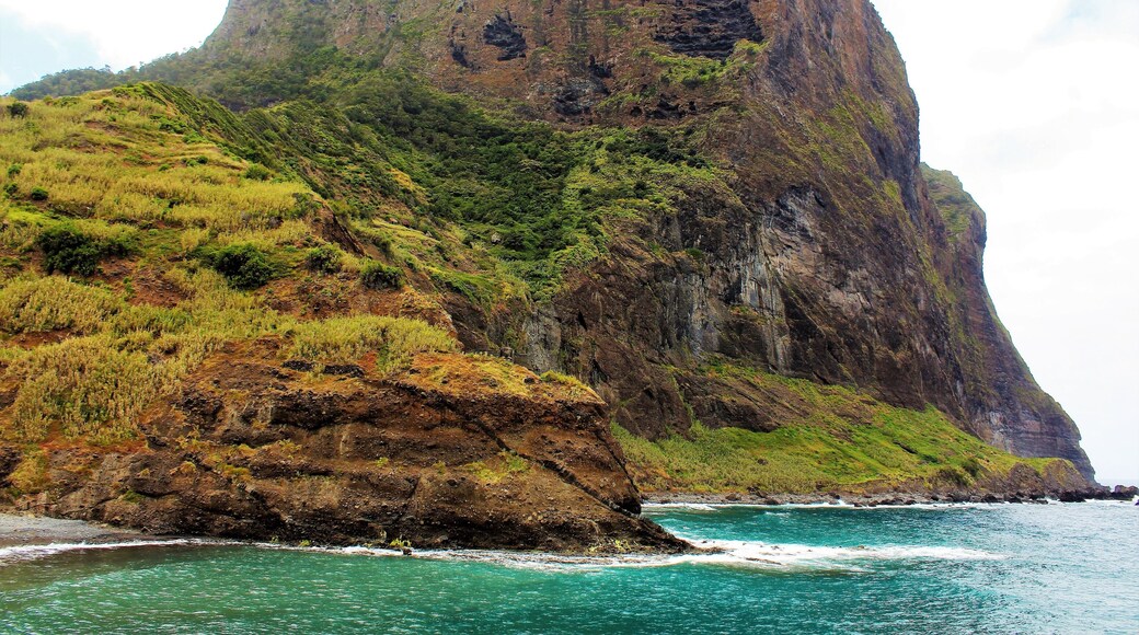 I took this in May on Madeira Island, Portugal! This is one of the most majestic sights I saw on this island paradise! Penha d'Aguia (Eagle Rock) is really impressive to see up close. It was even difficult to get all this in one photo. I need a better lens ;). I saw it after visiting a distillery in Porto da Cruz. Just a few meters away is this massive landscape! Porto da Cruz is located on the northeastern side of Madeira, definitely a picturesque part of the island! There was even some swimmers around where I took this picture. Everyone was having a good time there, either on the beach of walking along the pier :). There was other awesome views to the other side, as well. Incredible cliffs that seem to go on forever. And it was even foggy on that side, a big contrast to what you see here. I also think I saw Eagle Rock from another side, as well. And would love to return and see more views of it!!