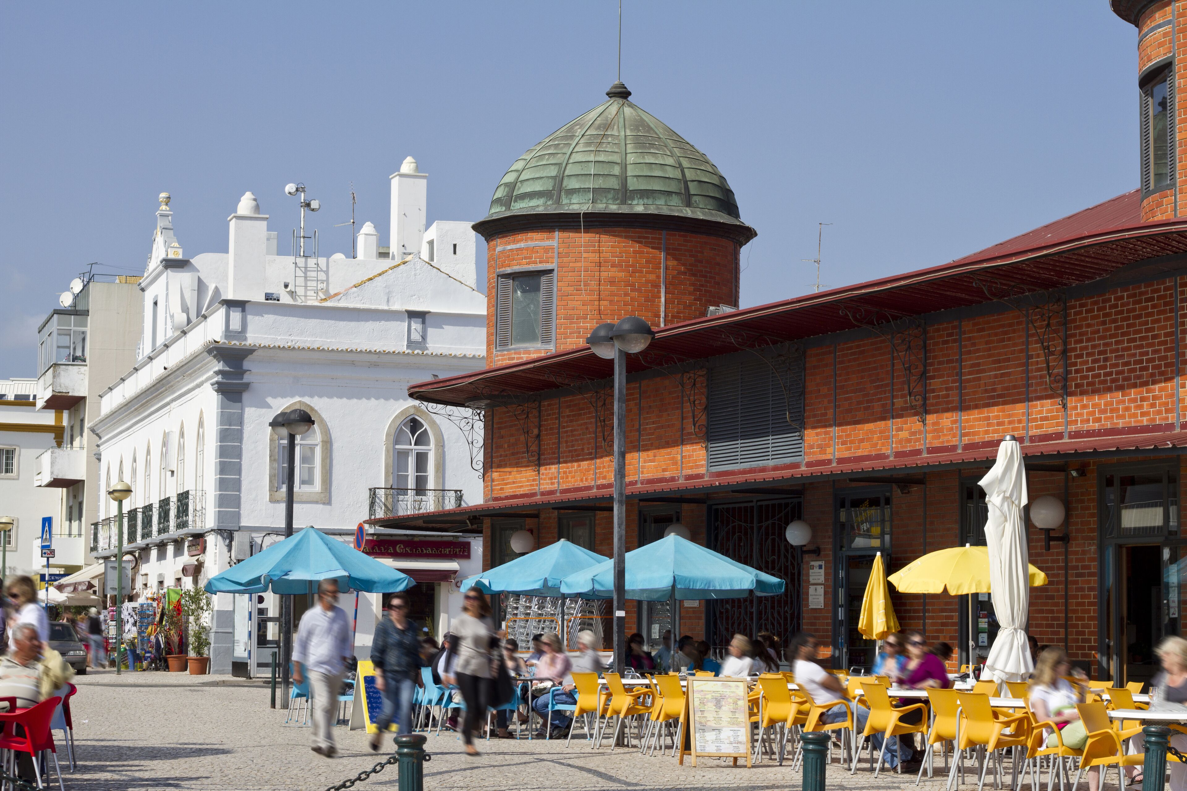 View of the traditional market area of the city of Olhao in Portugal, with people walking around.; Shutterstock ID 80527462