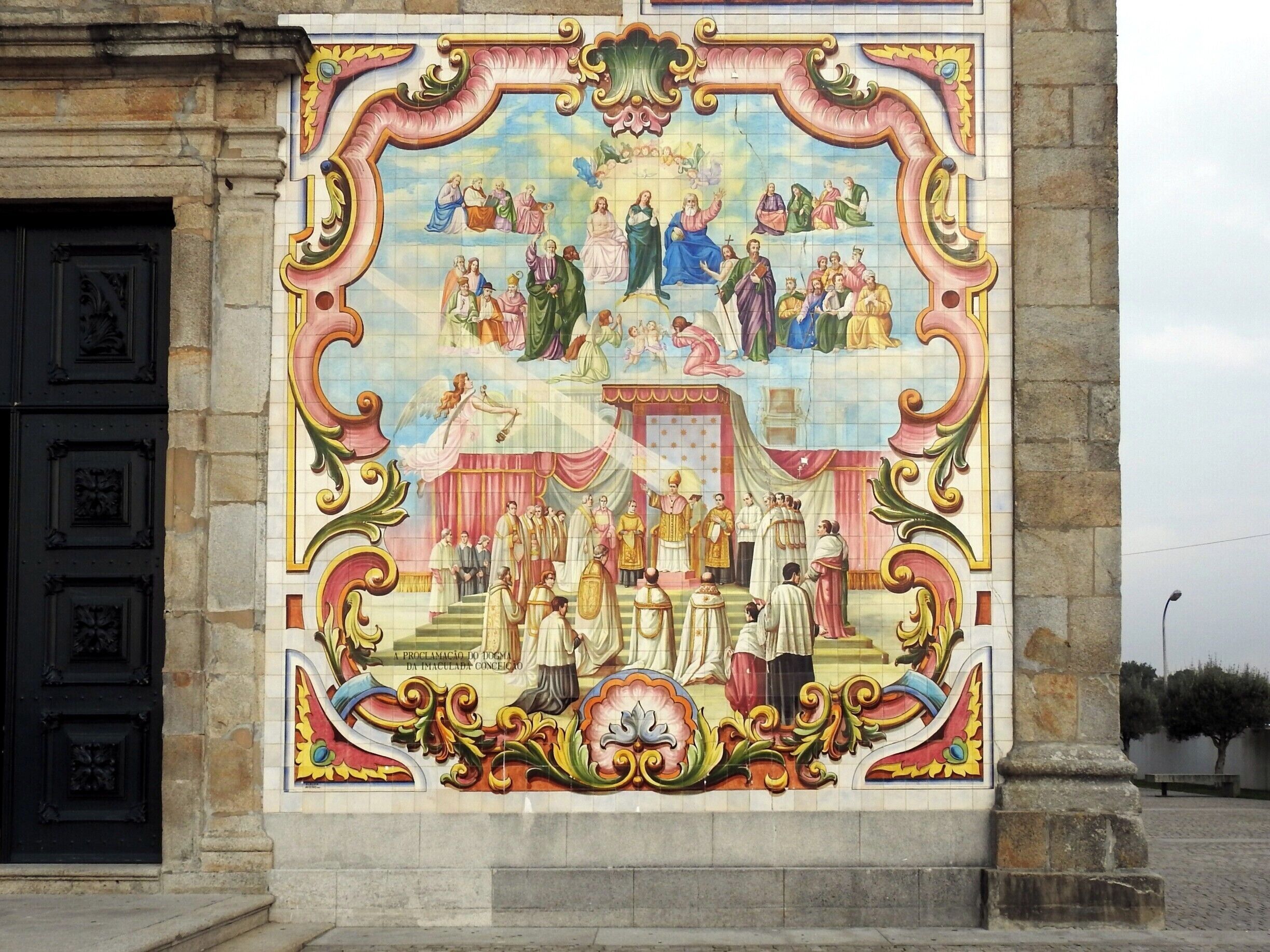 A detailed mural with religious figures and scenes, framed by ornate architectural elements.
