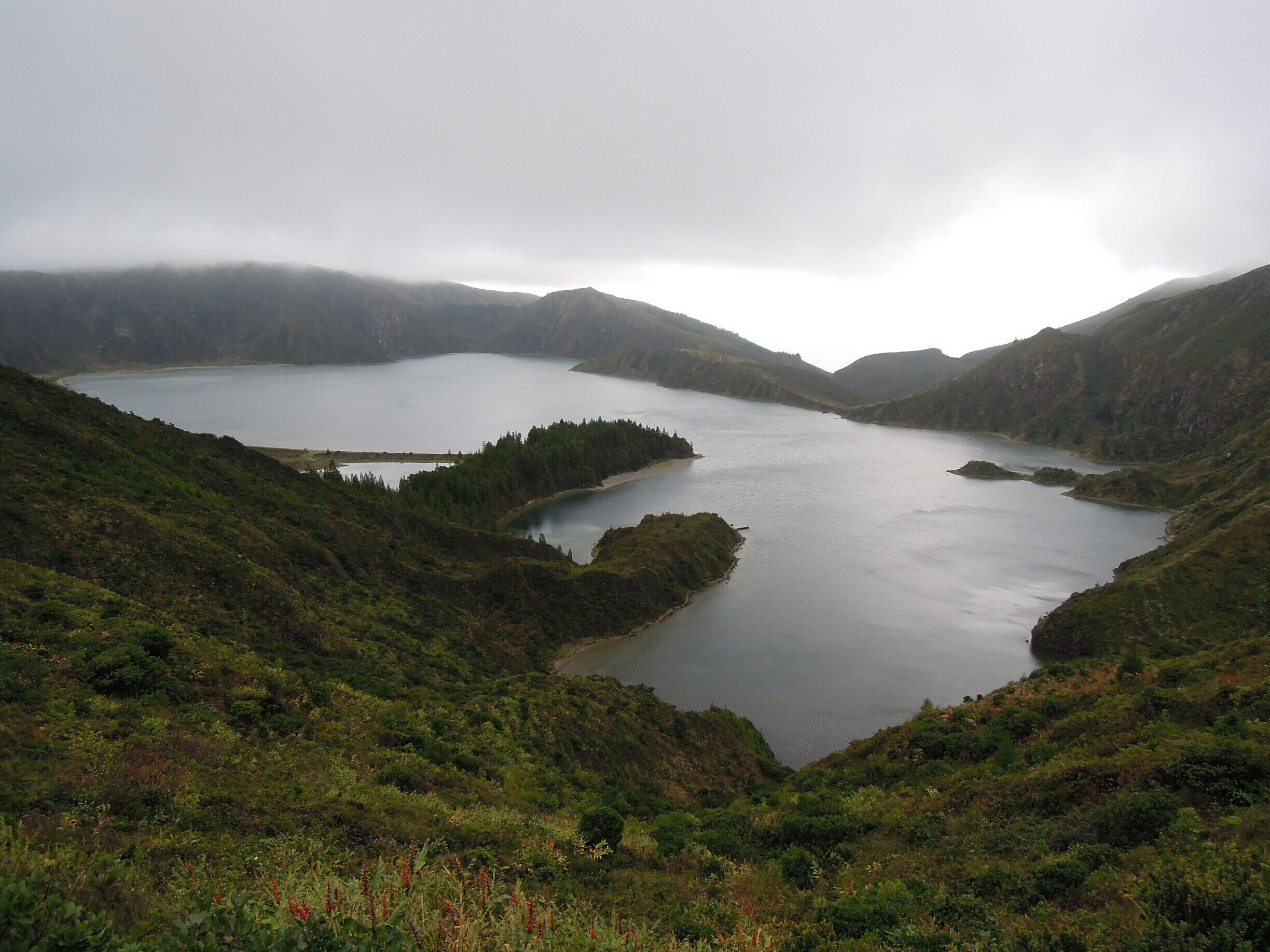 This lake is located at altitude and sometimes you'll see the clouds gently tumble over the sides of the volcanic crater inside which it's located.