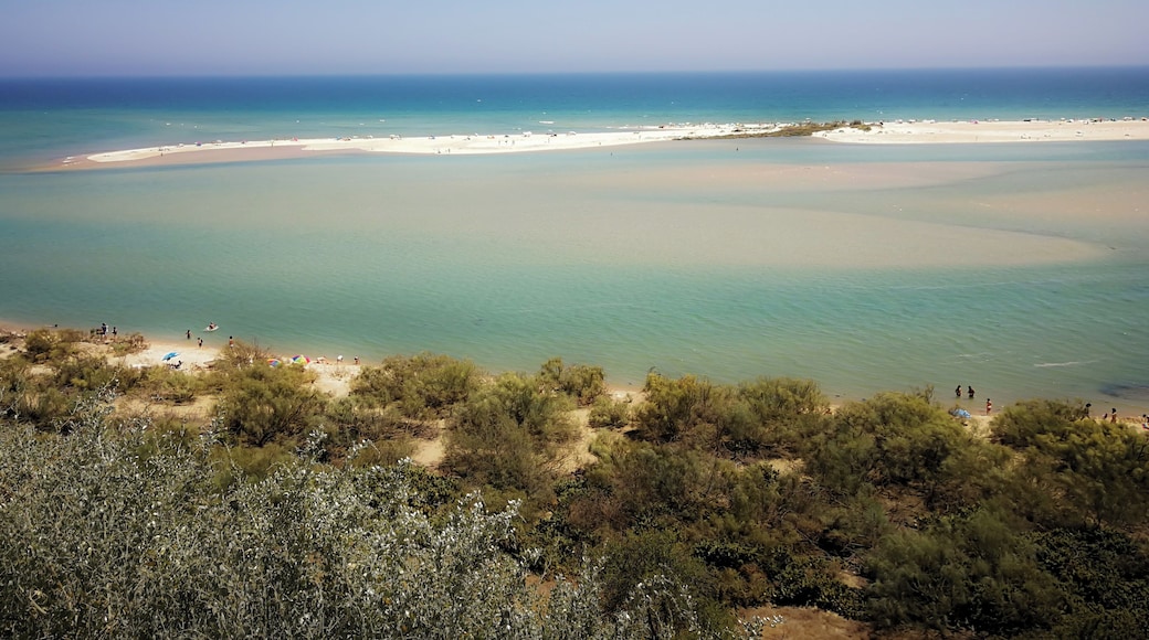 Almost like a watercolor painting, the view of the Ocean from the very small village of Cacela Velha in Portugal is enchanting and beautiful. During some hours is possible to cross to the landline walking, other times a boat is needed to get there.