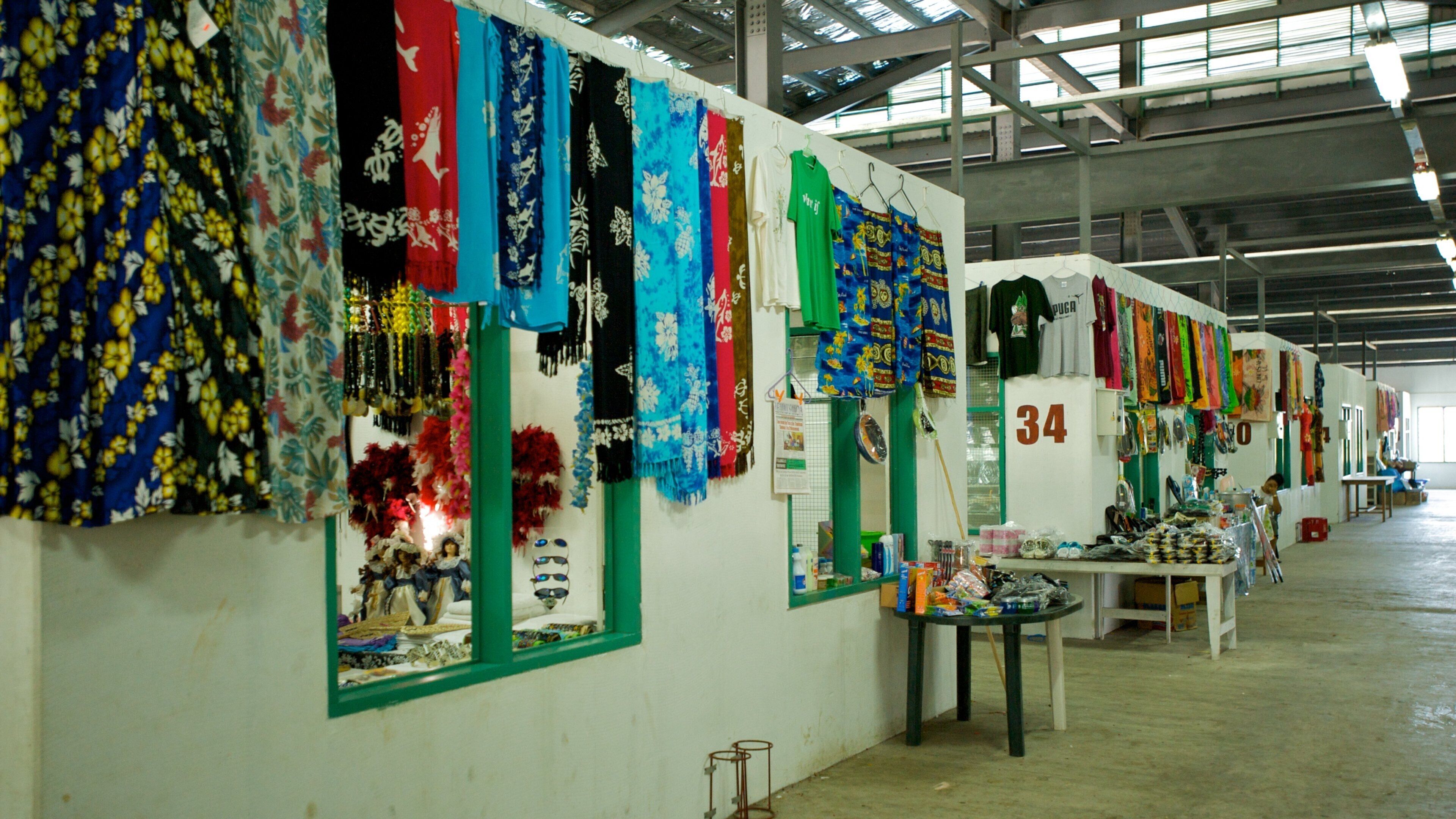 A market with colorful fabrics and textiles displayed on racks.