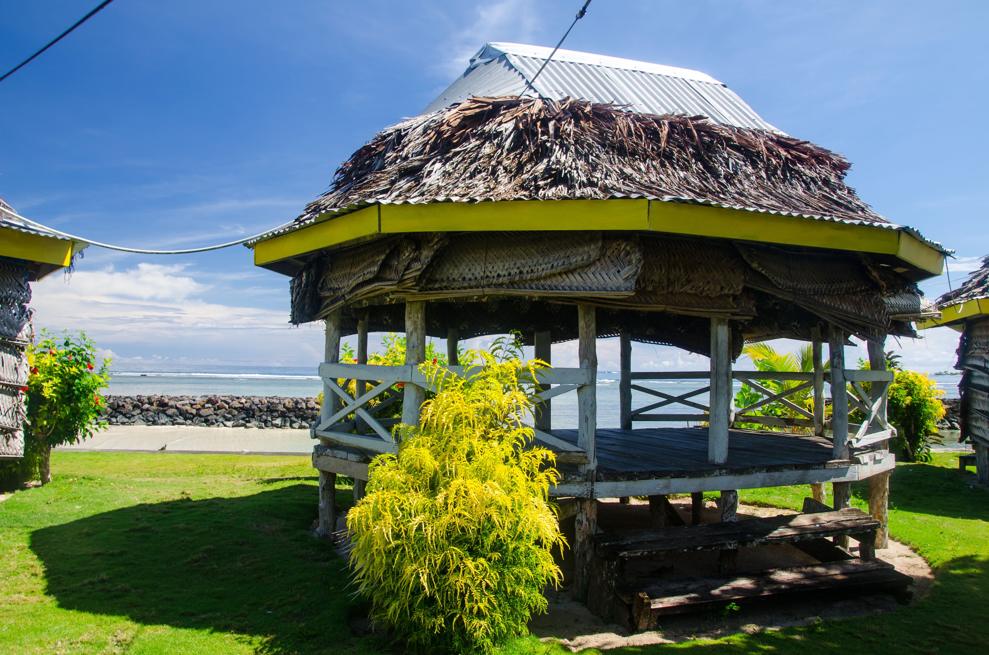 Closeup of a beach fale surrounded by the sea under the sunlight in Manase, Samoa