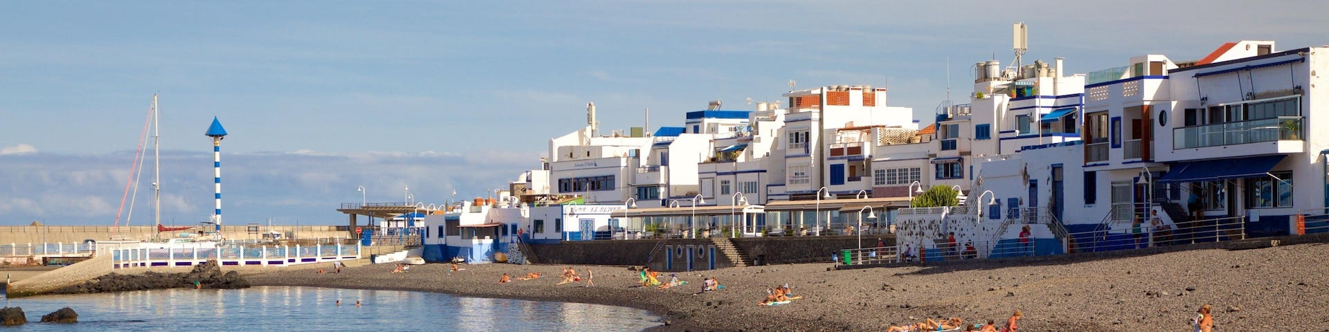 Agaete showing a pebble beach, a coastal town and general coastal views