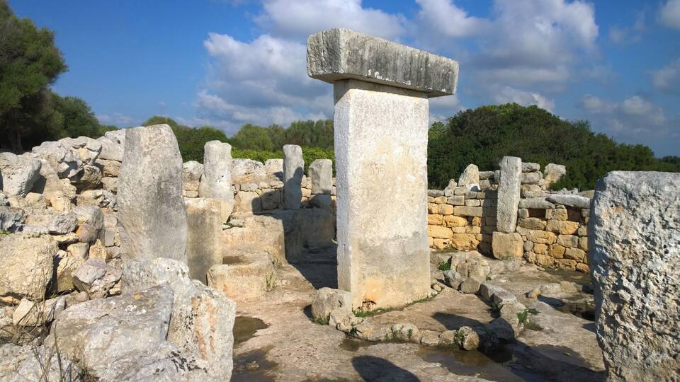 Ancient ruins with stone columns and walls.