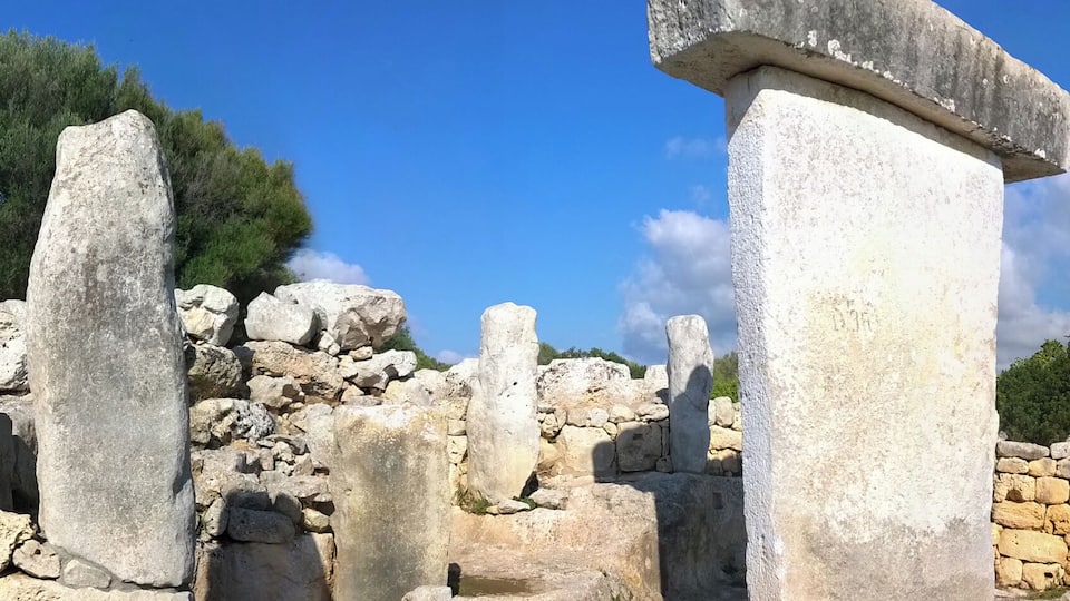 Ancient stone ruins with columns and walls.
