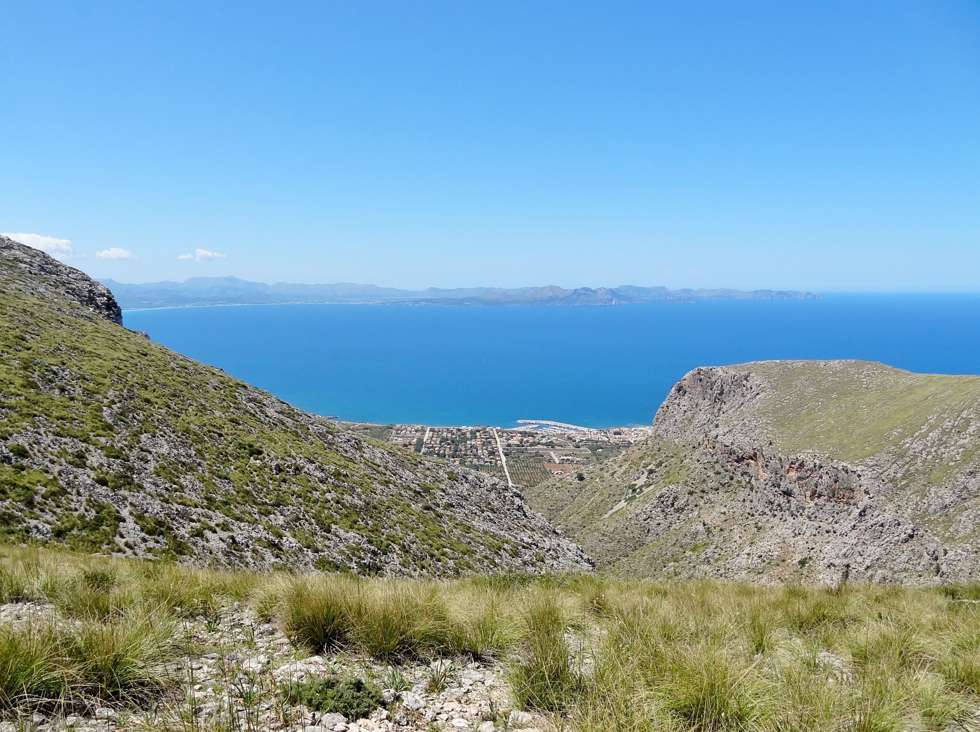 A coastal landscape with rocky terrain and a view of the sea.