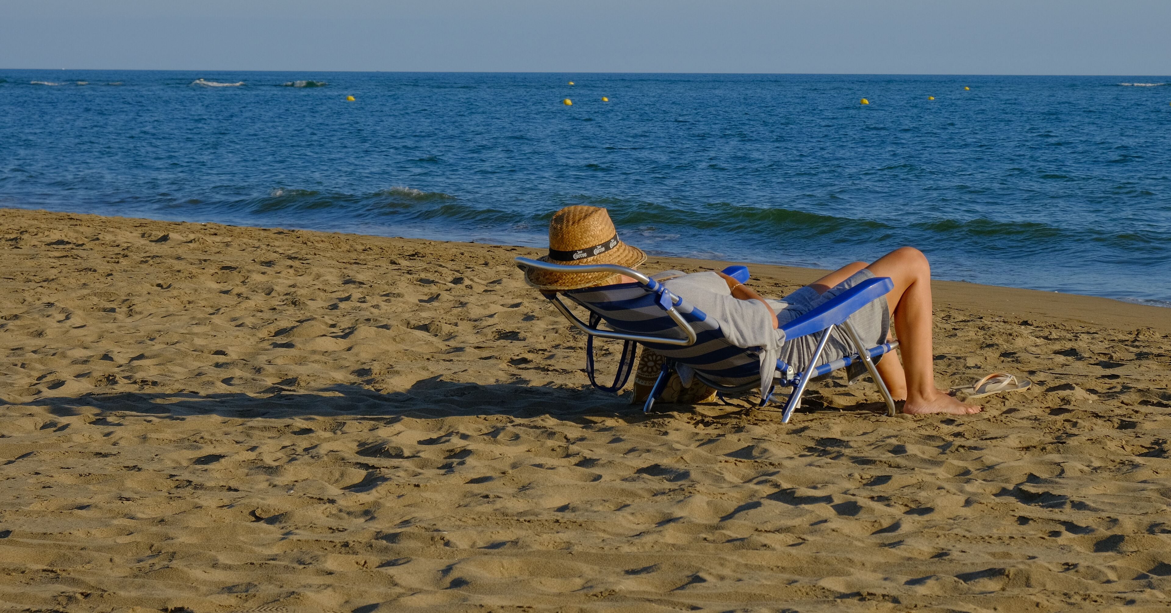 Man relaxing on the beach at Canela Island Ayamonte in Andalusia, Spain