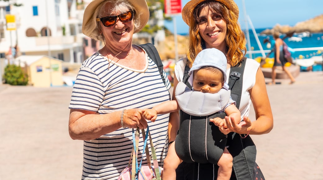 A family on the beach of Sa Tuna on the coast of Begur in summer, Girona on the Costa Brava of Catalonia in the Mediterranean