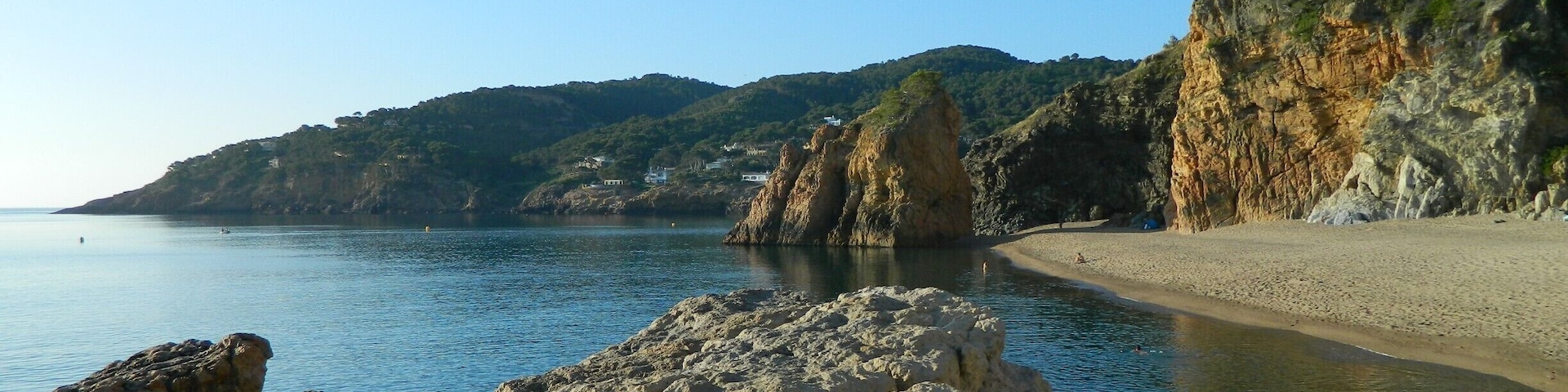 This was one of my favorite spots in Spain.  It has clear blueish-green water and was great for swimming and jumping off the rock in front.  There is a small cave in the far back corner on the beach which has many mosquito's at night (bummer). This photo was taking in the morning before it got over populated with naked Spaniards swimming and playing ping pong on the beach.  I would come here again I had a great time and camped 2 nights on the beach. The location of the beach is the closest I can do but it is referred by the locals as (Platjanudista).#Beach