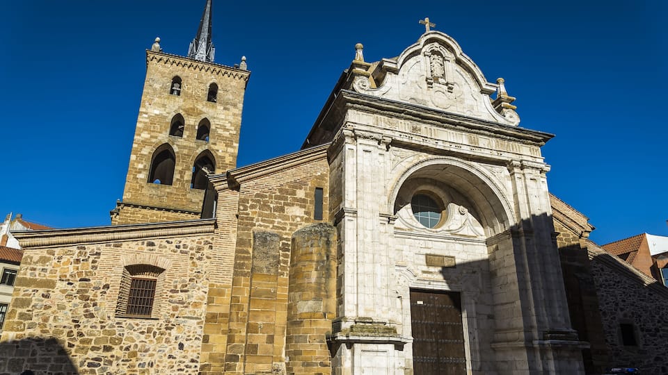 A historic stone church with a bell tower and a large arched entrance.