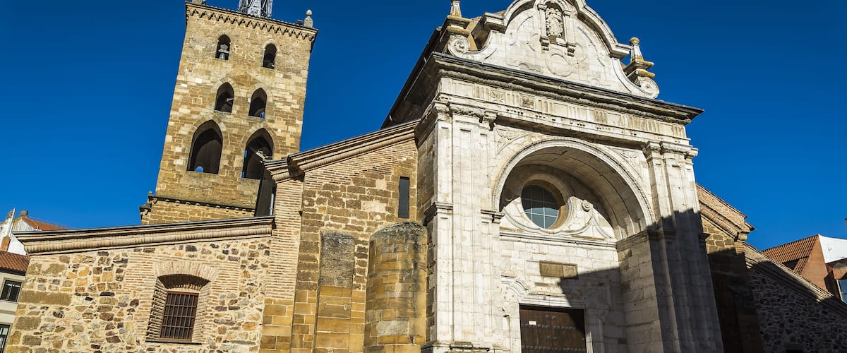 A historic stone church with a bell tower and a large arched entrance.