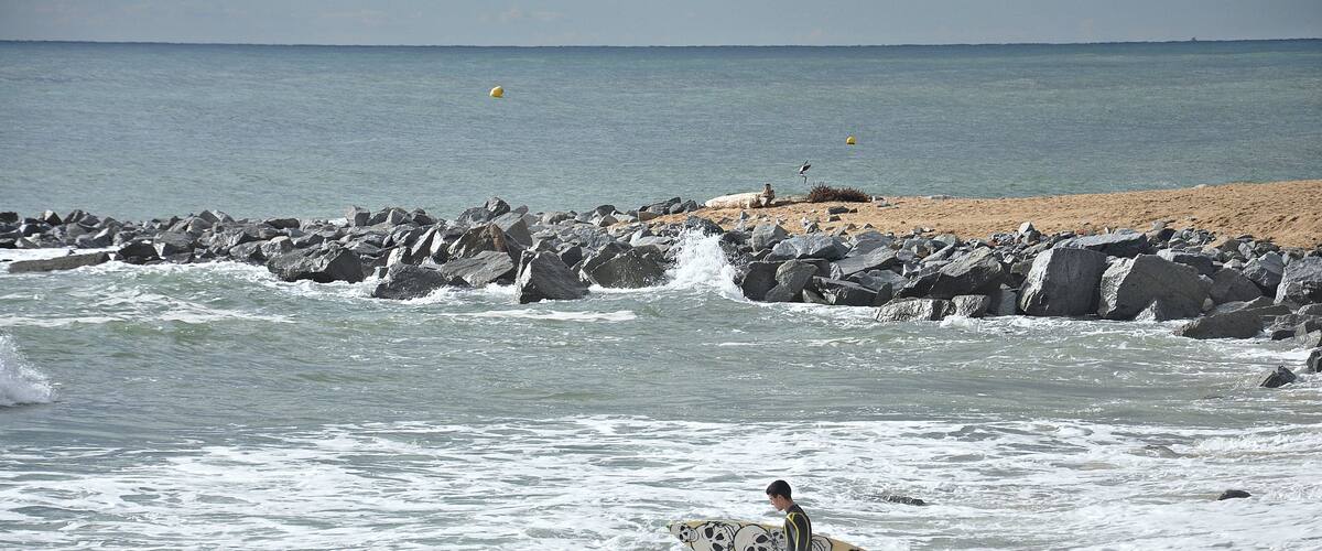 A rocky beach with waves crashing onto the shore.