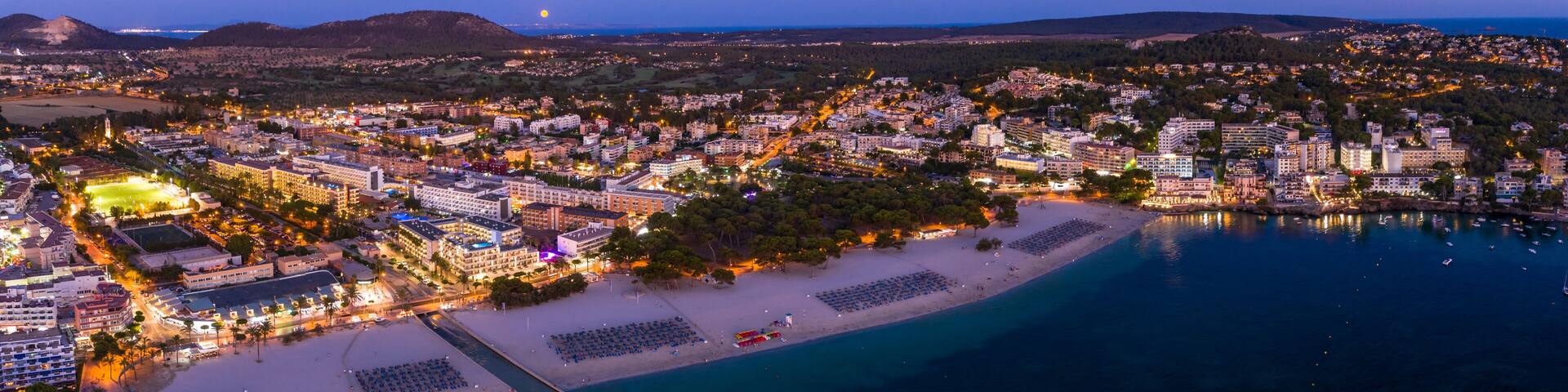 Spain, Balearic Islands, Mallorca, Calvia region, Aerial view over Costa de la Calma and Santa Ponca with hotels and beaches at dusk