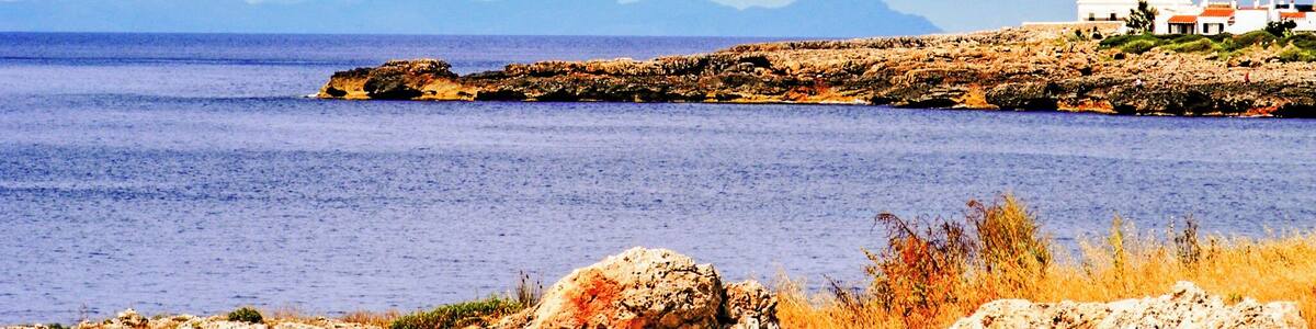 Black and White stripy lighthouse at the end of the resort.