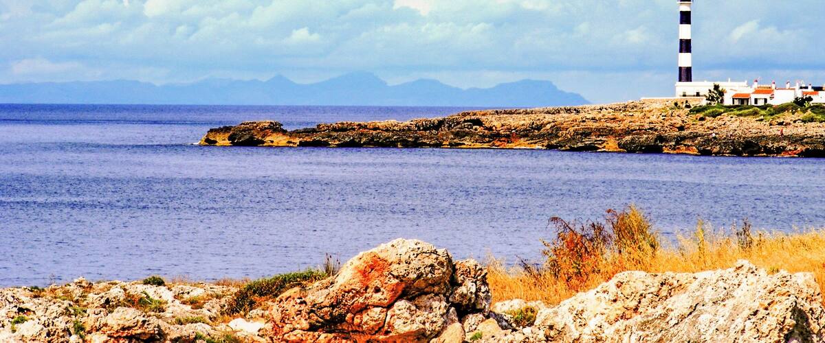 Black and White stripy lighthouse at the end of the resort.