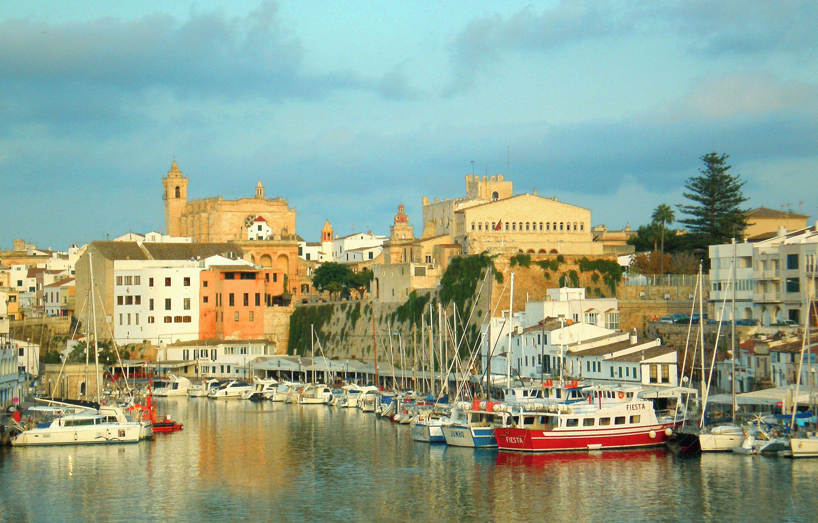 A harbor with boats, a church, and historic buildings.