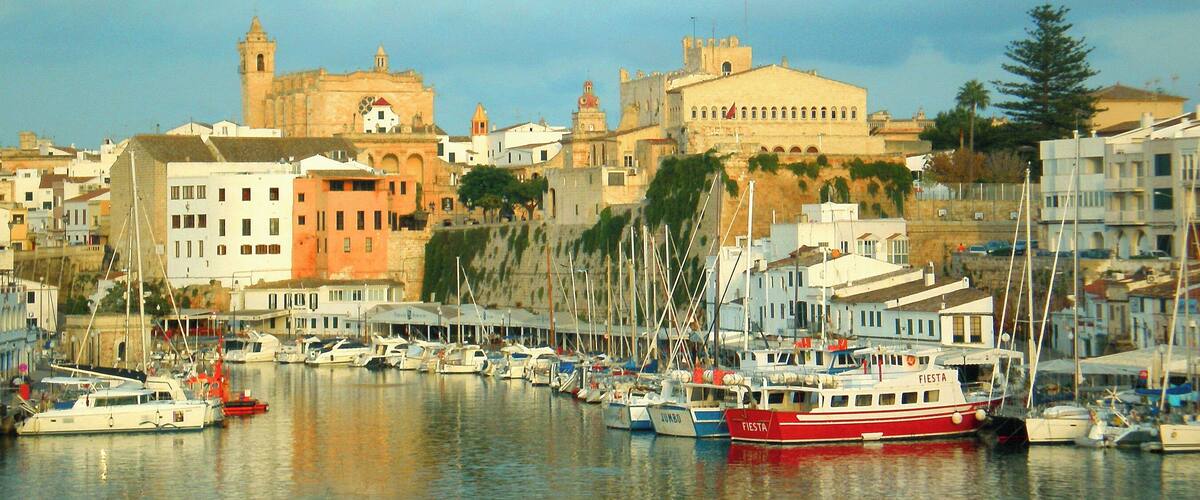 A harbor with boats, a church, and historic buildings.