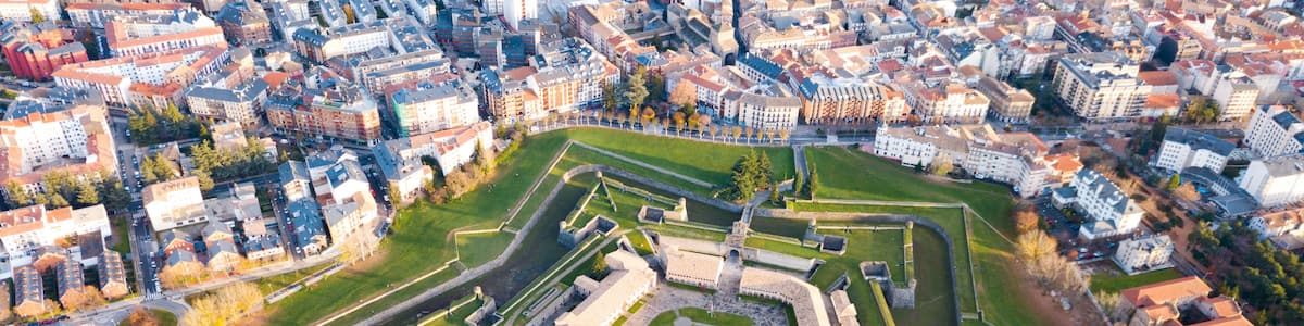 An aerial view of a historic fort surrounded by a cityscape.