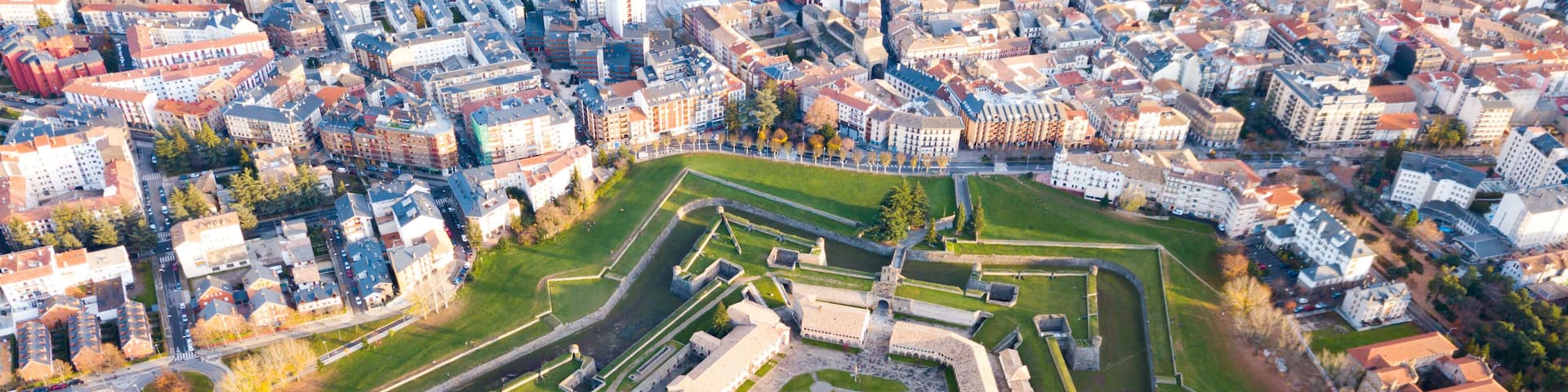 An aerial view of a historic fort surrounded by a cityscape.
