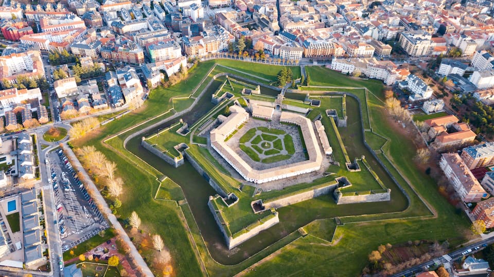 An aerial view of a historic fort surrounded by a cityscape.
