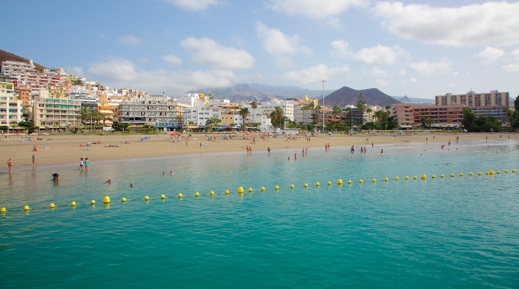 Los Cristianos which includes a coastal town, a beach and general coastal views