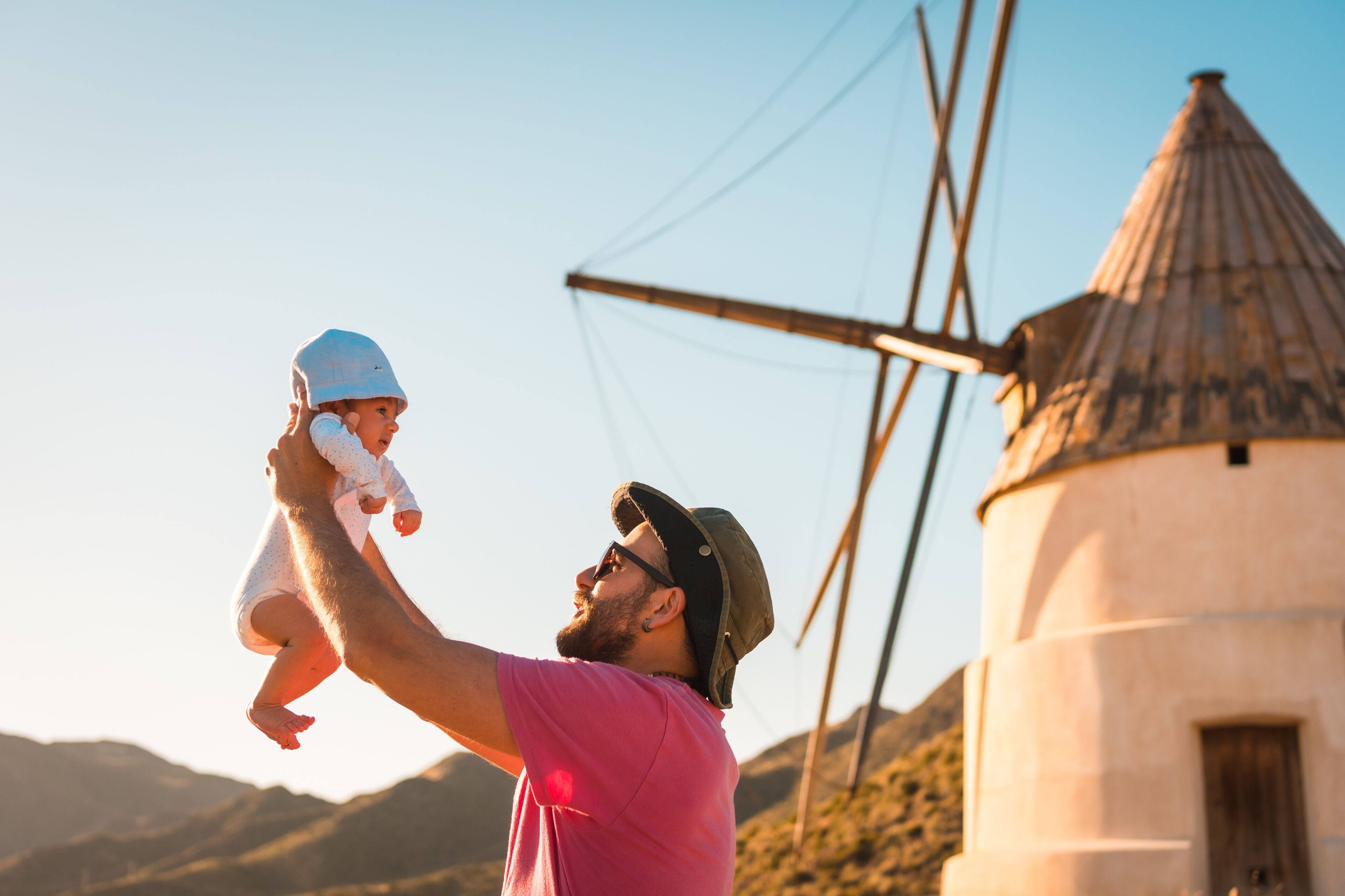 A young man enjoying with his son in the Natural Park of Cabo de Gata, a mill in the town of San Jose, Almeria. Spain