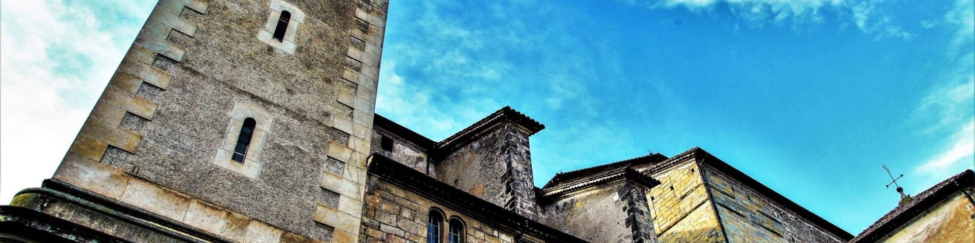 A historic building with a clock tower and a clear blue sky.