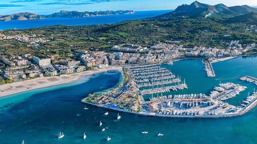 Aerial Sunrise Over Alcúdia Bay: Water front Resorts and Hotels over look the Beach, and Port in Mallorca, Spain