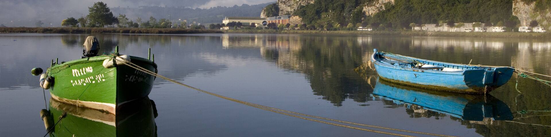 Two tied boats. Small fishing colored boats moored at Ribadesella, Asturias, North Spain, Europe.