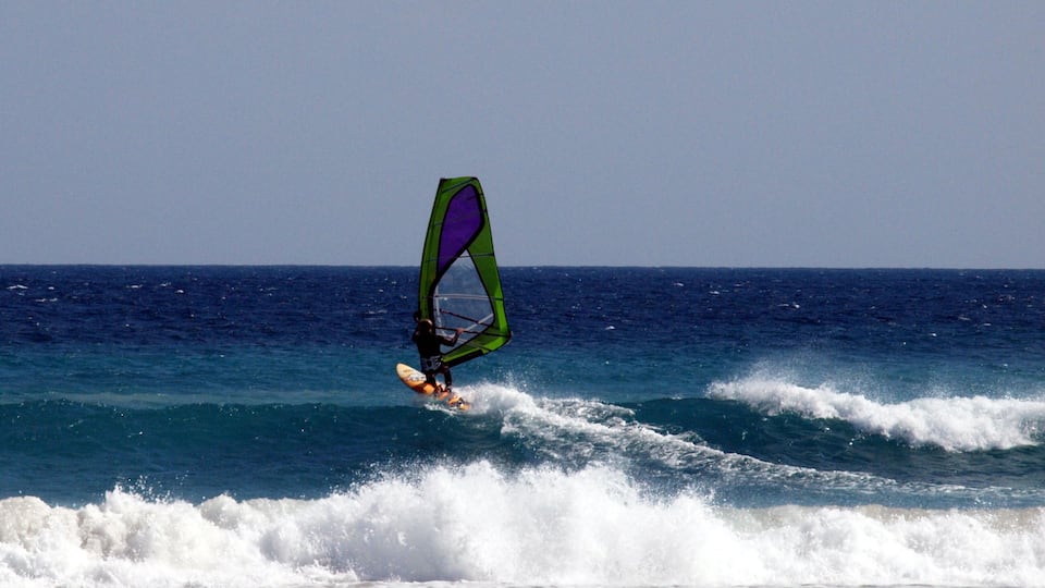 A person windsurfing on the ocean.