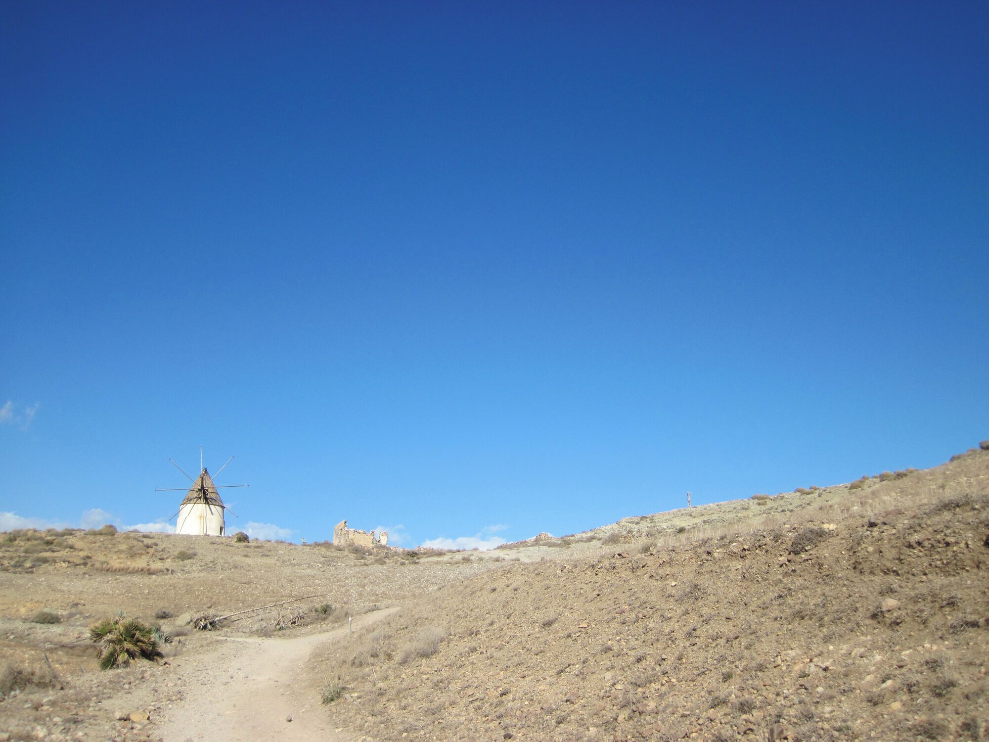A sleepy little beach town during off-season, surrounded by arid hills, in the Parque Natural de Cabo de Gata. Walk southish along the beach, up the hill, at the end of the paved streets you will find a short trail that leads to Playa de Los Genoveses. 
