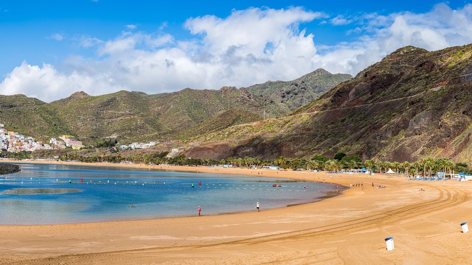 Las Teresitas Beach with its golden Sahara sands, nestled by Tenerife lush Anaga Mountains, and the charming San Andres village.