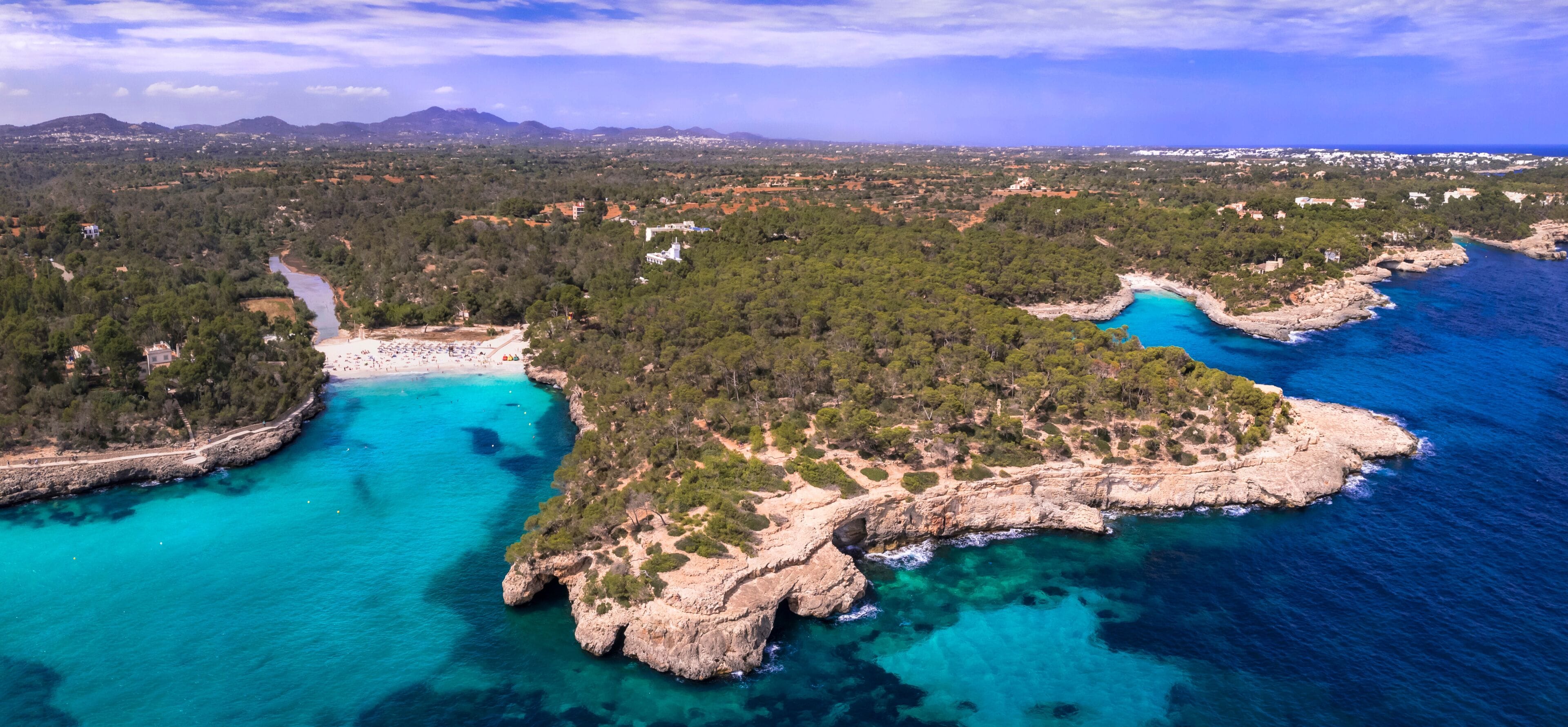 Aerial Drone panorama of S'Amarador Beach in Mondrago National Park. Scenic View of Pristine White Sand Turquoise Water and Pine Forest. Mallorca Majorca Island Spain. 8kHigh Quality