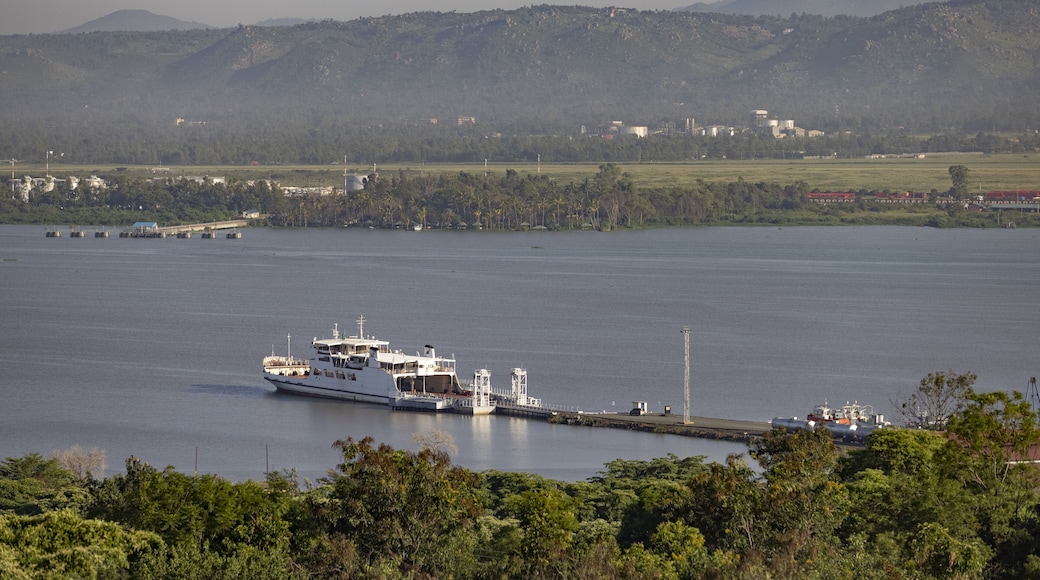 Kisumu, Kenya - 13 May 2021: View of a ferry docked at a pier on Lake Victoria, the tranquil waters reflecting the soft morning light against the backdrop of distant hills.