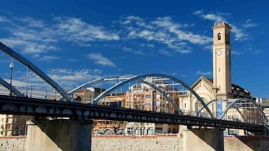A bridge with a clock tower in the background.