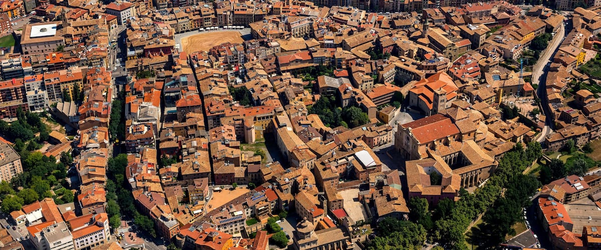 An aerial view of a densely packed urban area with historic architecture and narrow streets.