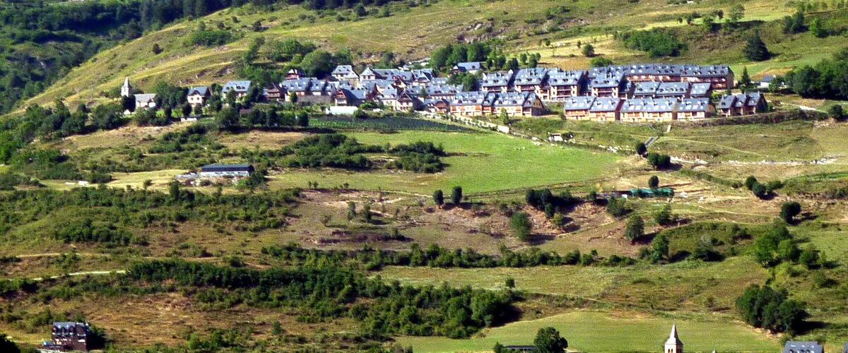 A hillside village with traditional houses and a church.