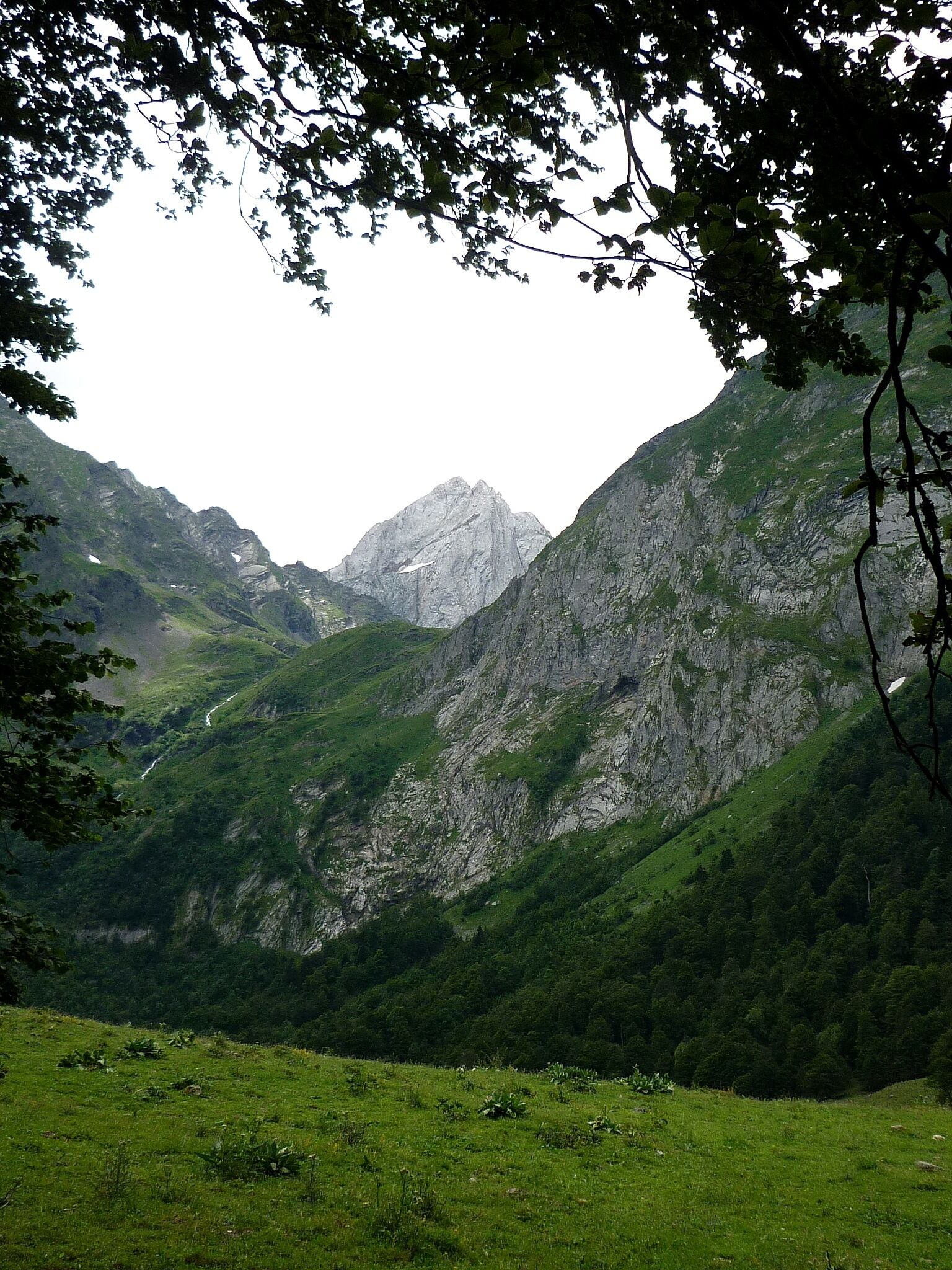 A mountainous landscape with a valley and a river.