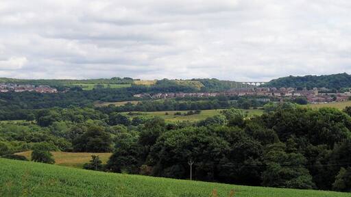 Hown's Gill Bridge. This now carries the C2C path. The housing to the left is The Grove and to the right Moorside leading to Castleside. Photograph taken from Mosswood on A68.