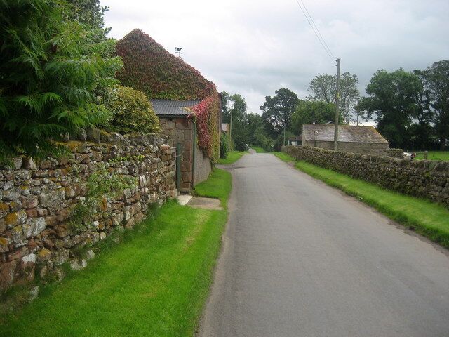 Road through Brampton This looks south east along the road that runs through the small Cumbrian village of Brampton.