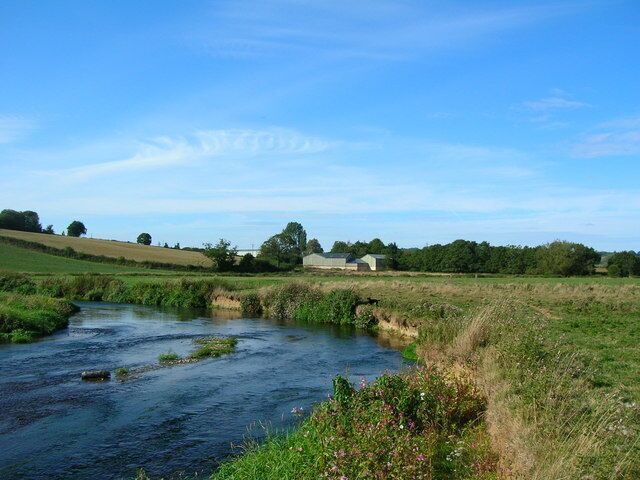 Axe. The building shown on the edge of the Axe floodplain is the Kilmington sewage works. There are trout in the river here hiding in the shaded parts of the river.