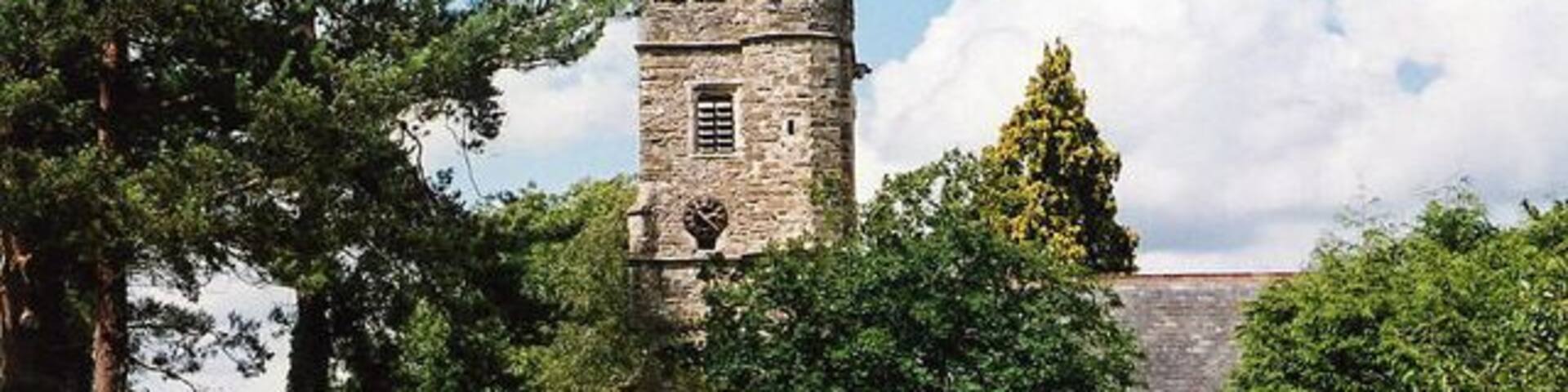West tower and south porch of St Peter's parish church, Dalwood, Devon, seen from the south
