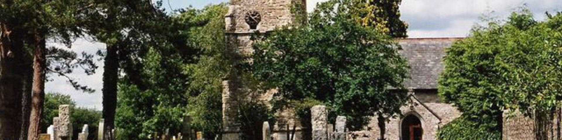 West tower and south porch of St Peter's parish church, Dalwood, Devon, seen from the south
