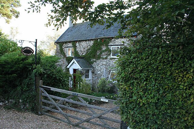 Dalwood: Telegraph Cottage. Looking south west by the road from Axminster to the A30 via Stockland Hill. Telegraph Cottage is probably very close to the site of Dalwood Common station on the manned signalling telegraph line from the Admiralty in London to Devonport. It functioned from 1806 to 1814, during the Napoleonic wars. It seems somewhat surprising that the station is this far south at this point, but the Plymouth line was an extension of one to Portsmouth which had opened in 1796. Today another communications system operates a couple of field lengths away: the high mast of Stockland Hill TV Station is a landmark for miles around